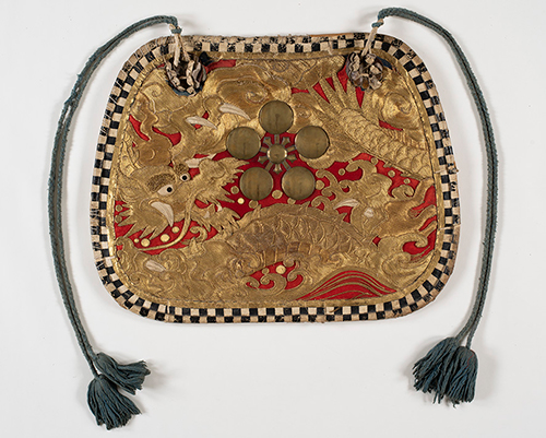 羅紗地に金糸で竜を描き、中央に金属板の梅鉢紋を付けた板状の飾り