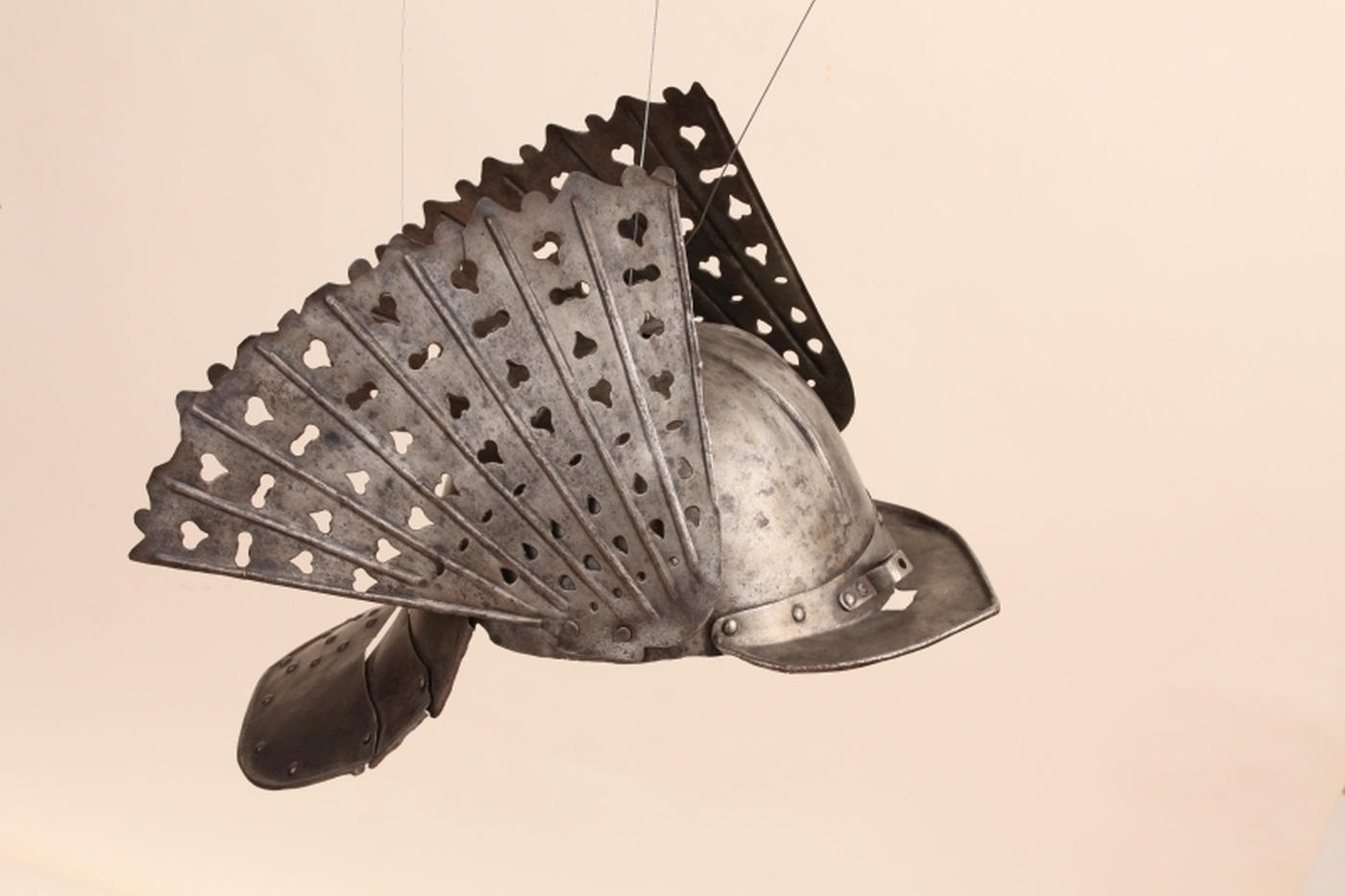 A metal helmet with feather-like decorations on both sides.
