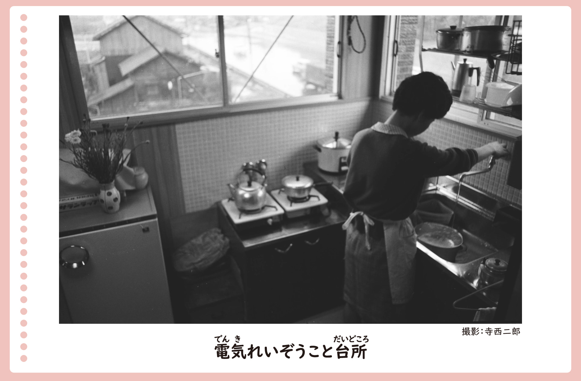 電気冷蔵庫がおかれた台所の風景。昭和40年。エプロンを付けた女性が料理をしている。ガスコンロや炊飯器とともに冷蔵庫がある。冷蔵庫は女性の腰くらいの高さ。